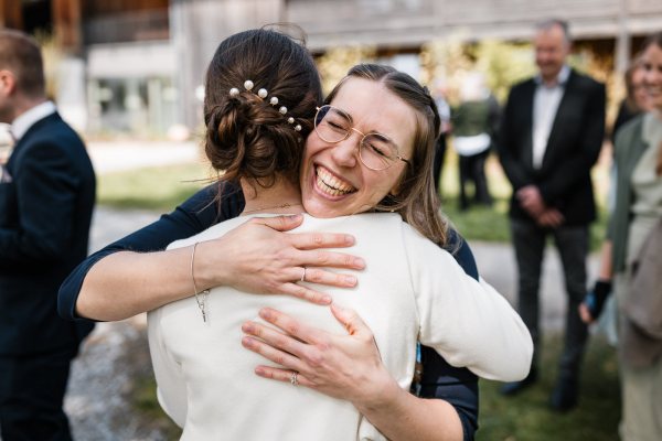 Herzliche Umarmung bei der Hochzeit von Bettina und Jonas auf der Gutsalm Harlachberg